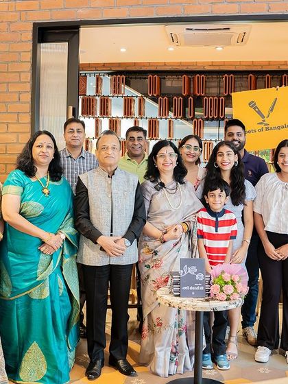 A beautiful family portrait taken at the book launch, celebrating the author's achievement together.