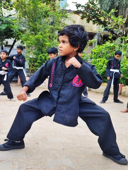 Another shot of a young girl demonstrating a powerful and stable horse stance. Her form is a testament to her hard work and the effectiveness of our training methods.