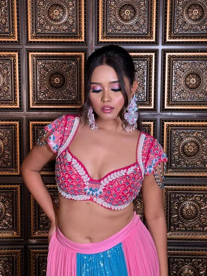 A modern and edgy ponytail with face-framing pieces. This style is perfect for a Sangeet or cocktail party, complementing a bold and colorful outfit.