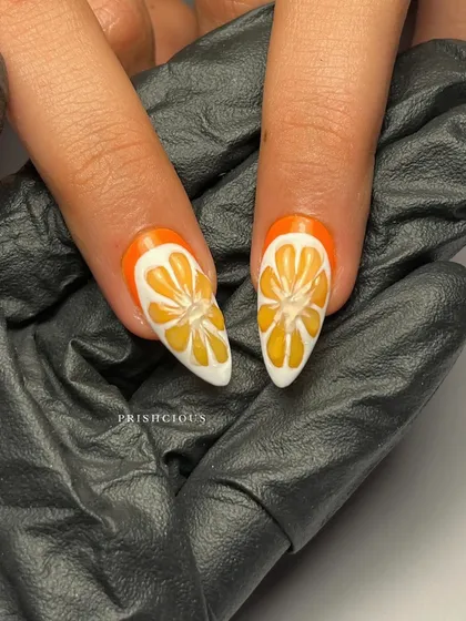 A macro shot of the hand-painted orange slice nails. I used different shades of orange and white to create a realistic, juicy effect.