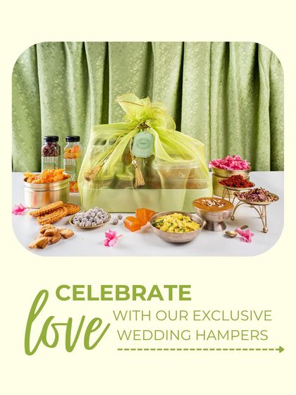 Celebrate love with my exclusive wedding hampers. This hamper, wrapped in a delicate potli, is surrounded by a colourful array of traditional sweets and snacks, perfect for gifting during the wedding season.
