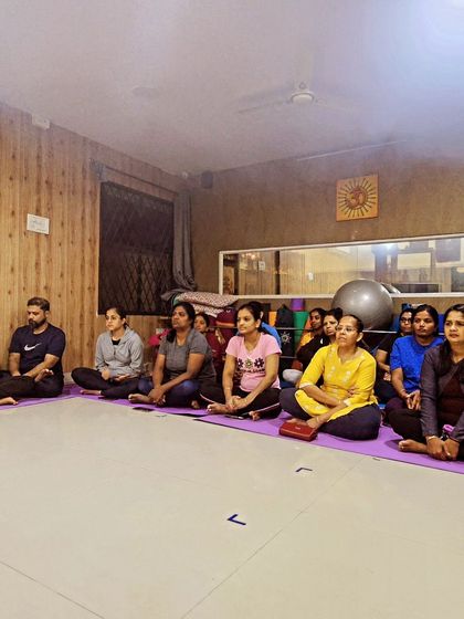 Our community members seated in our studio, attentively participating in the Rathasaptami celebration.