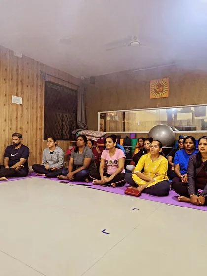 Our community members seated in our studio, attentively participating in the Rathasaptami celebration.