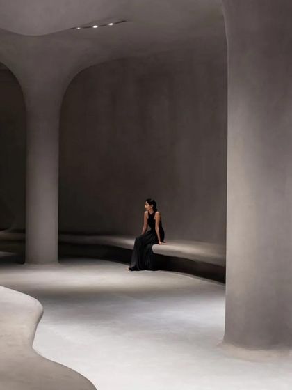 An interior view of the Aatma Manthan Museum, designed for self-reflection. The space features organic, cave-like forms with smooth, rendered walls and integrated seating, creating a serene and contemplative atmosphere.