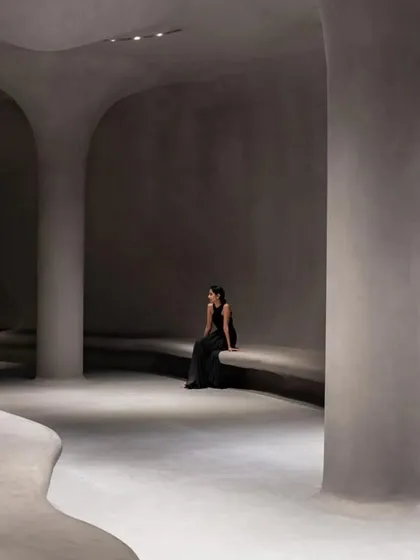The museum's interior spaces are defined by sculptural columns and benches that appear to grow out of the floor, creating a truly organic architecture.