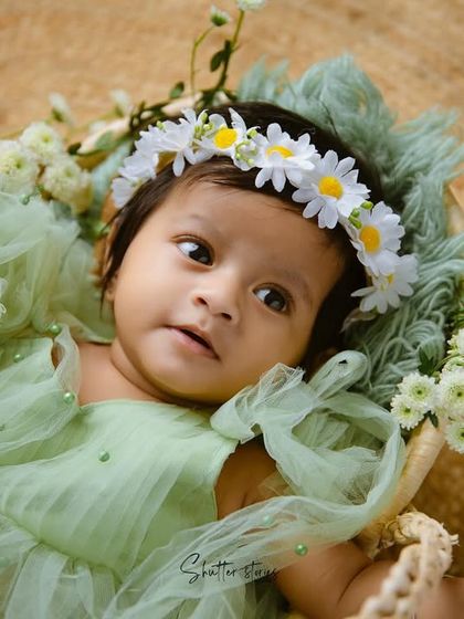 A curious look from this little one during her green and white floral milestone session.