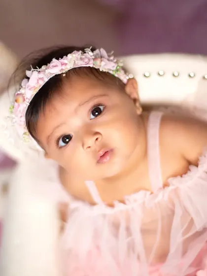 A beautiful close-up portrait from a unicorn-themed sitter session, capturing the baby's innocent gaze.