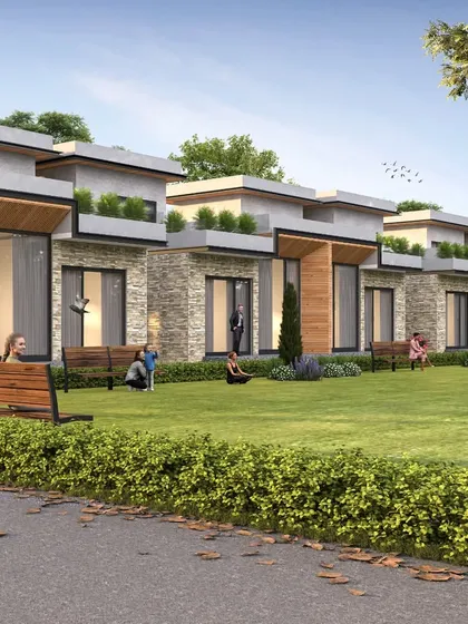 A row of luxury villas designed as part of a larger housing development. The design focuses on creating a community feel with shared lawns and seating areas, while each villa has its own private space.