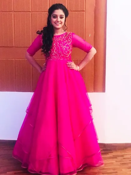 I was filled with gratitude to design this vibrant pink gown for the talented actress Ankita Amar on the popular TV show 'Nammane Yuvaraani'. The gown features delicate gold embroidery on the bodice and a flowing, layered skirt.