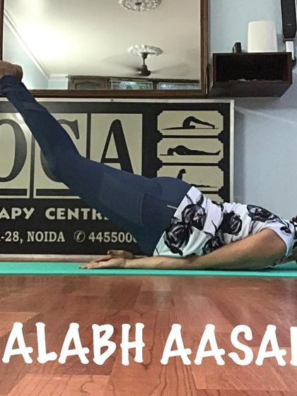 A clear side view of Shalabh Aasan, showing the engagement of the back muscles to lift the legs.