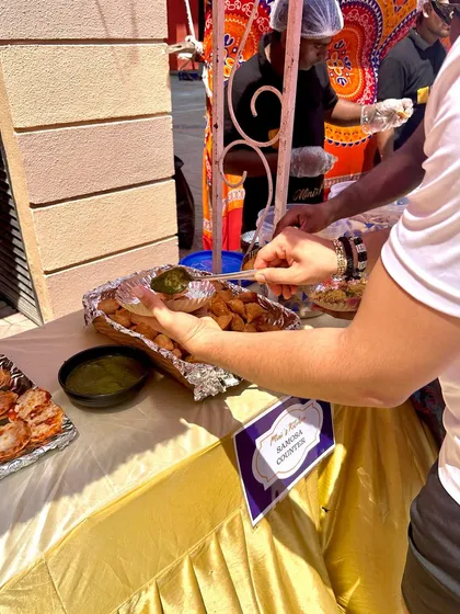 A guest enjoying a fresh plate from our Samosa counter at a Holi party. Simple, classic, and always a hit.
