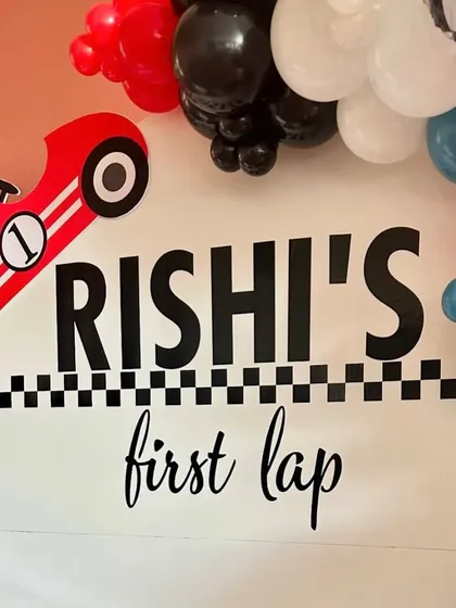 The graphic details of the 'Rishi's First Lap' sign, designed to look bold and speedy.