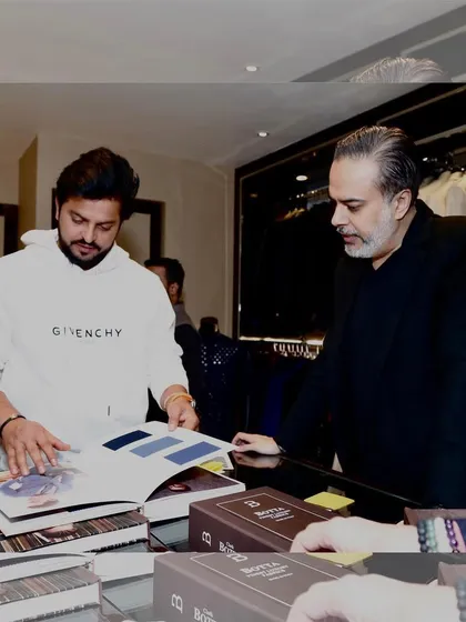 It was a pleasure to host cricketer Suresh Raina at our store. Here, we are looking through fabric catalogs to find the perfect materials for his bespoke garments, a process I enjoy with every client.