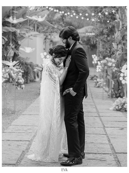 A tender black and white moment between the newly engaged couple, captured in a beautifully decorated walkway.