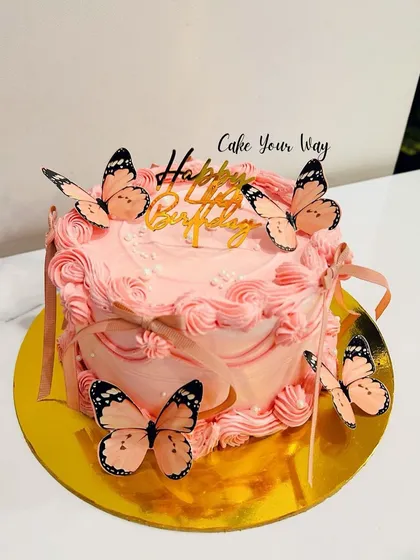 Flutter into sweetness with this vintage-style butterfly cake, featuring delicate piping and pretty pink butterflies.