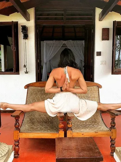 A reverse prayer pose combined with a middle split. This showcases how we can work on both upper body shoulder mobility and lower body flexibility simultaneously.