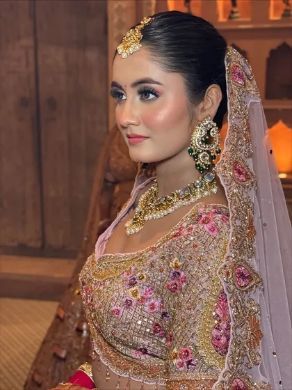 A side profile that captures the beautiful contour and highlight on the bride's cheekbones, adding a touch of glamour to her soft look.