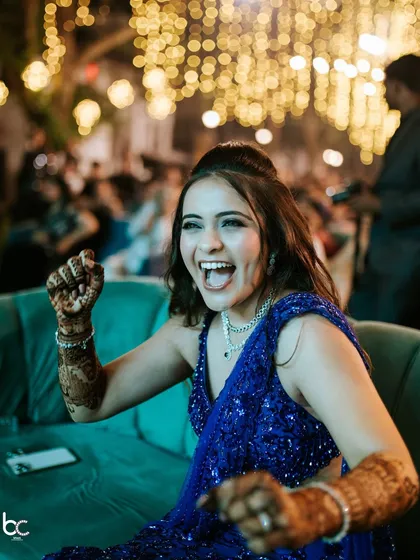 The bride's infectious energy as she cheers during a Sangeet performance, a perfect example of the candid, joyful moments I love to capture.