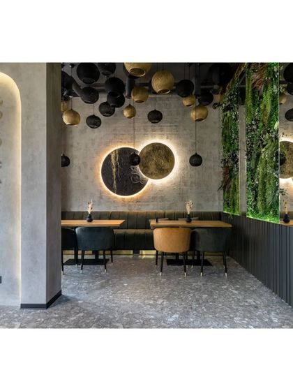 Another view of the dining area, showing how the different design elements come together. The backlit circular art pieces serve as a focal point against the industrial-style wall.