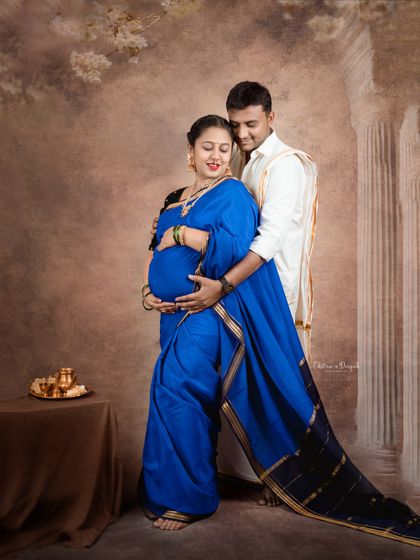 A royal blue saree makes a bold and beautiful statement. This couple's portrait is a perfect blend of traditional elegance and modern style.