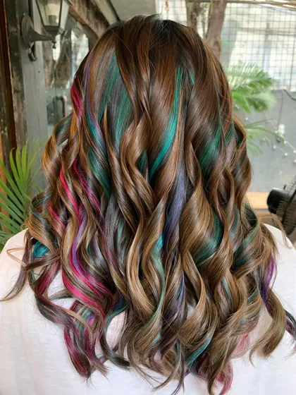 Gems and chocolate. A beautiful brunette base with pops of pink, green, and purple, which were achieved with bleach.