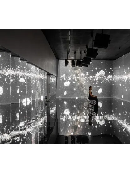 An immersive digital art installation within the museum uses light and reflection to create a powerful, otherworldly experience.