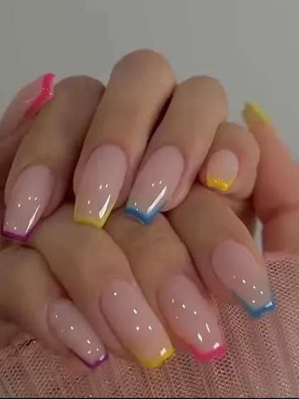 A vibrant rainbow French manicure on long, coffin-shaped nails. Each nail features a different bright color for a playful and eye-catching effect.