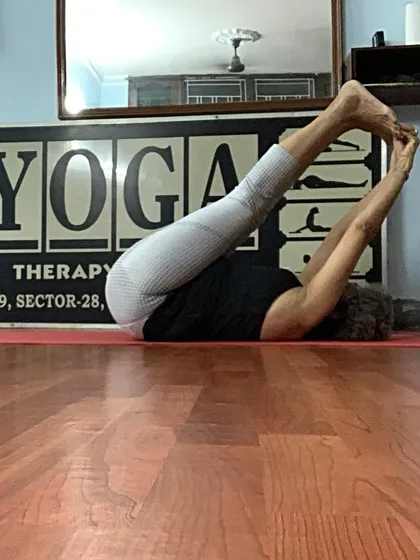 A variation of Plow Pose, showing deep compression and spinal flexion.