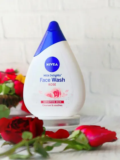Nivea's rose-infused face wash is styled with fresh roses and a clean, white brick background to emphasize its key ingredient and gentle cleansing promise.