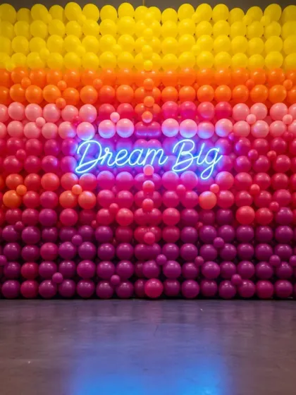 This custom balloon wall was the star of a recent brand activation event. I used an ombre color scheme to match the client's branding and added a 'Dream Big' neon sign to create the perfect photo opportunity. It's a great way to boost engagement at your conference or launch.