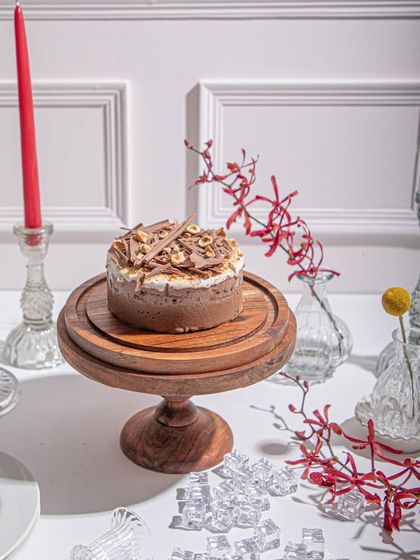 Our reinvented Black Forest Ice Cream Cake, featuring layers of chocolate, cream, and cherry, topped with delicate chocolate shavings. It's a nostalgic classic, reimagined.