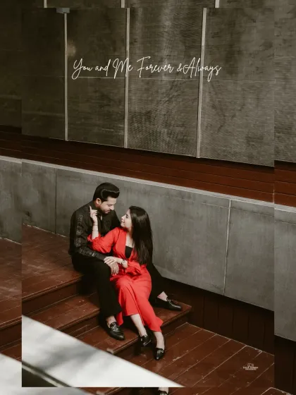 A romantic shot of the couple sitting on wooden steps in a modern setting, looking at each other with love.
