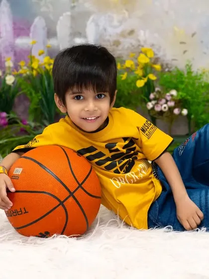 Future basketball star in the making. We can incorporate your child's favorite sports or hobbies into a fun and personalized photoshoot, like this basketball-themed session.