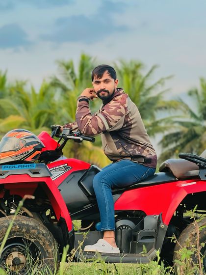 Posing with my Polaris ATV against a backdrop of coconut trees. This is the kind of tropical, natural scenery you'll be riding through when you join me on an adventure.
