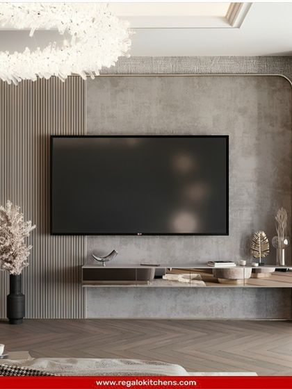 This TV unit uses a mix of grey stone, wood, and metallic finishes to create a layered and luxurious look. The floating console adds a sense of lightness.