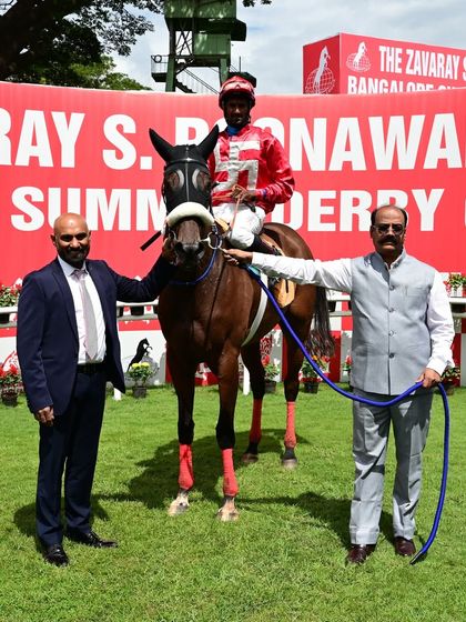 N R I Victory, winner of The Delhi Cup, poses with jockey S. Antony Raj and the owner.