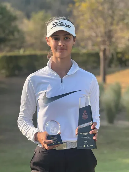 A close-up of Lavanya Gupta proudly holding her awards from the Asian Junior Masters.