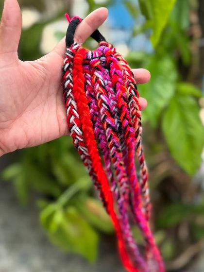 Another color option for our hair braids, this time with shades of pink and red.