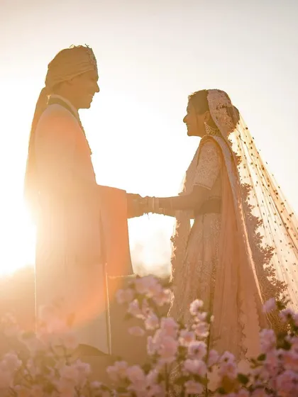 Avisha and Youry stand face to face in the glowing Moroccan sun. This backlit silhouette captures their connection and the stunning beauty of their destination wedding.