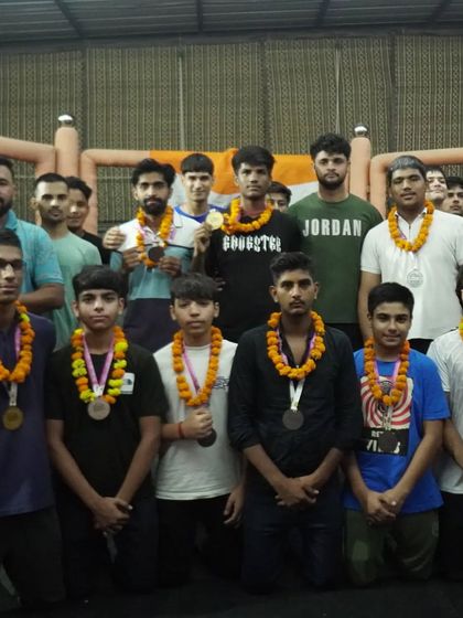The team celebrating our kickboxing champions with garlands after their return from competition. We celebrate our wins as a family.