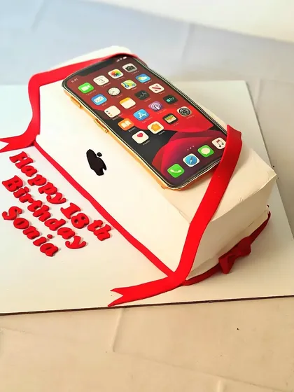 The ultimate gift for a tech lover: an iPhone cake! This sculpted cake is designed to look like a brand new iPhone in its box, complete with a red ribbon.