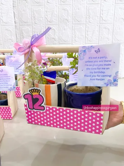 A hand presents the 12th birthday return gift basket, showing its perfect size for a memorable party favor.