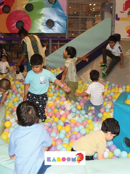 A snapshot of a typical day at Kaboom, with kids exploring every inch of the ball pit and slide area.