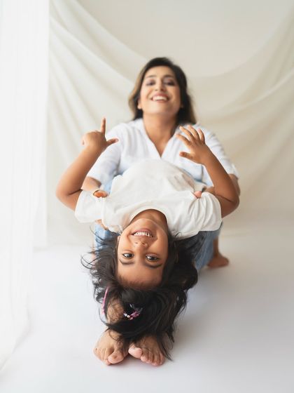 Upside-down fun! Studio sessions don't have to be stiff. I love encouraging playfulness to capture genuine smiles and laughter.