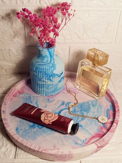 An extra-large round tray with a pink, blue, and purple marble effect, styled with a matching ribbed vase. This is a great example of a custom order we created.