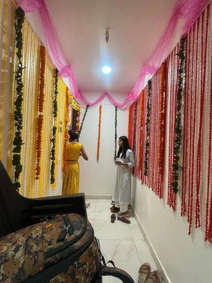 A beautiful and traditional flower decoration for a housewarming ceremony (Griha Pravesh). I used strings of marigold and other flowers to create a welcoming and auspicious entrance.