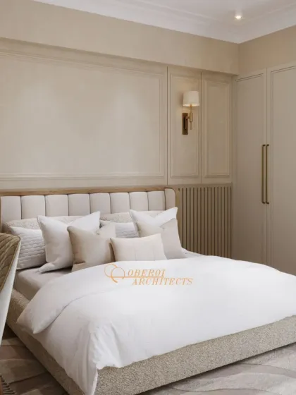 A serene bedroom with classic wall paneling and a soft, neutral color palette. The integrated wardrobe maintains a clean and seamless look.