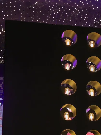 A detail shot of the custom-designed wall with illuminated niches, creating a visually striking feature next to the starry ceiling.