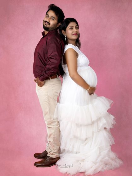 A fun back-to-back pose against a vibrant pink background. This shot is full of personality and style.