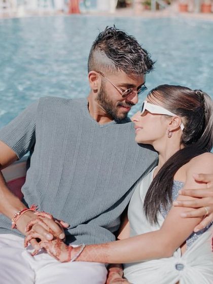 An intimate moment between the bride and groom during their relaxing pool party at Khimsar Fort.